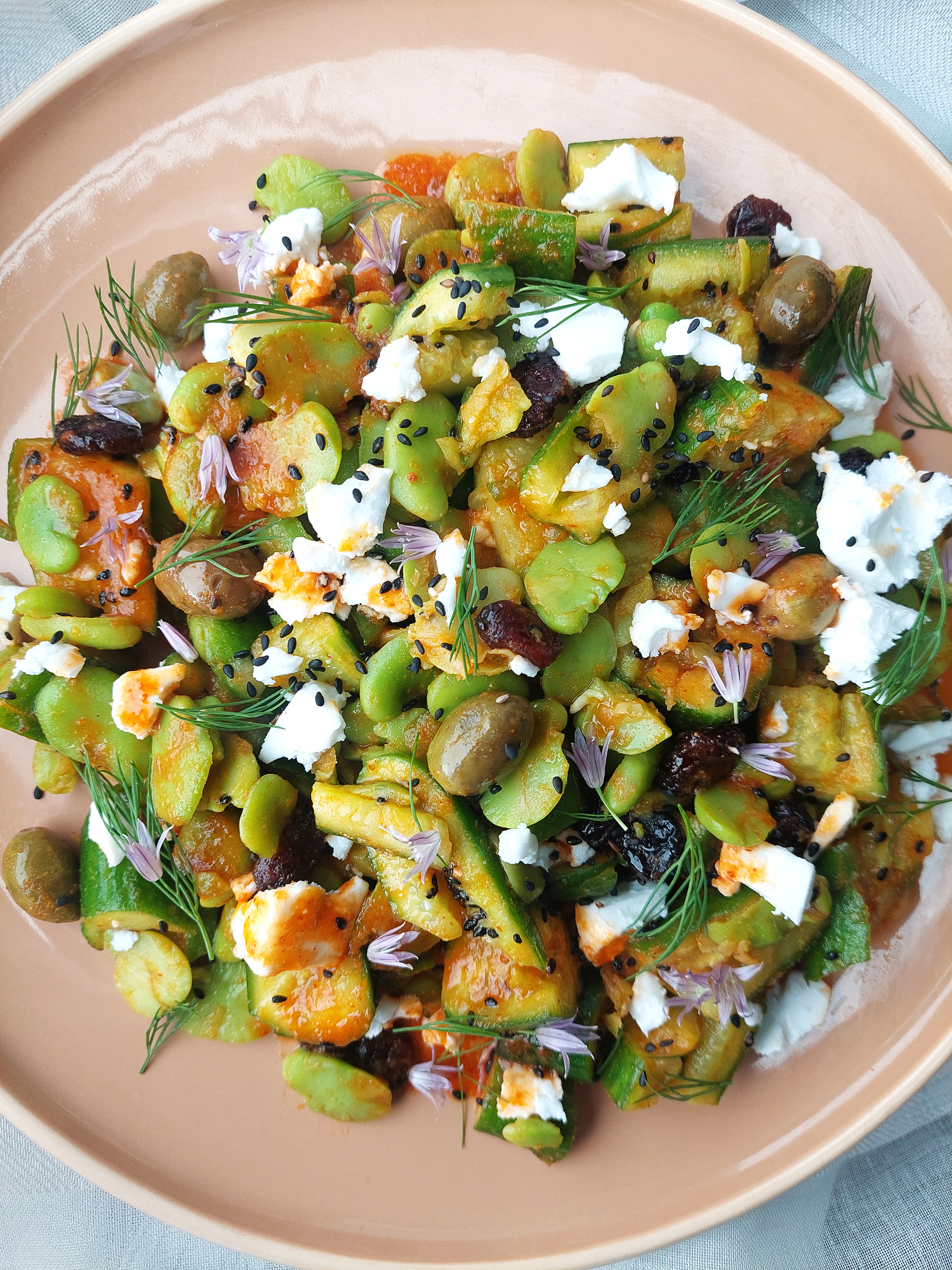 SPICY HARISSA SMASHED CUCUMBER SALAD WITH FAVA BEANS, CRANBERRIES AND PLANT-BASED FETA